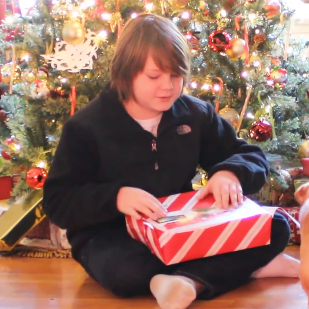 Kid opening "Extreme Chores" gift box