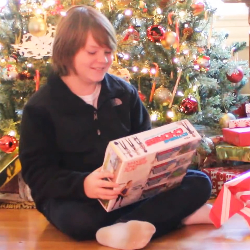 Kid opening "Extreme Chores" gift box