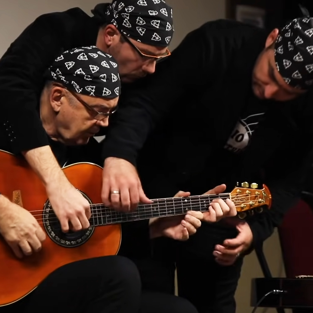 Three men playing guitar