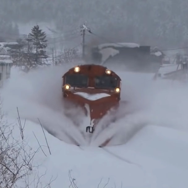 Trains with snow plows turn snow into white tidal waves Madly Odd!
