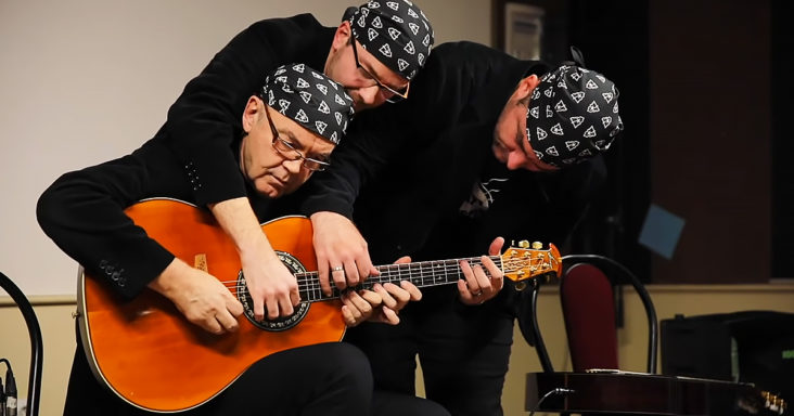 Three men playing guitar