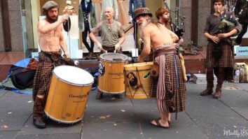 Scotsmen performing bagpipe and drum music