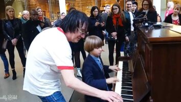 Terry Miles and an little boy playing a public piano