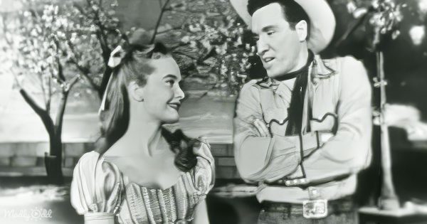 Florence Henderson and John Raitt close together, performing 'People Will Say We're In Love' with a mix of TV studio and Broadway flair.