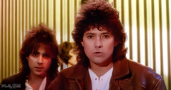 The band Starship on stage, vibrant lights and an enthusiastic crowd framing their performance in 'Nothing's Gonna Stop Us Now.'