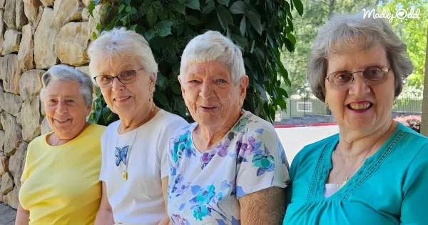 4 spry senior ladies smiling for the camera