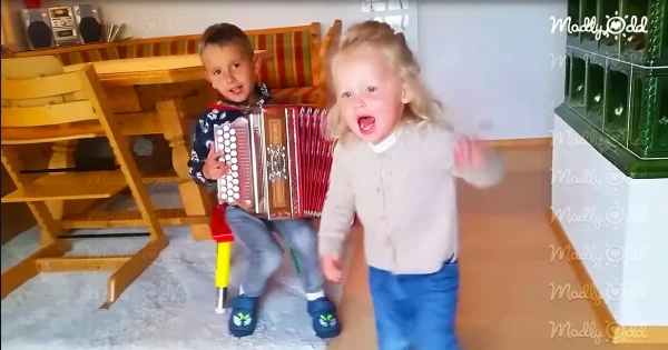 Tiny accordion player and dancing sister perform