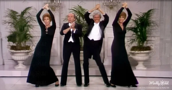 Two 1970s comedians performing an exaggerated dance routine on a variety show stage