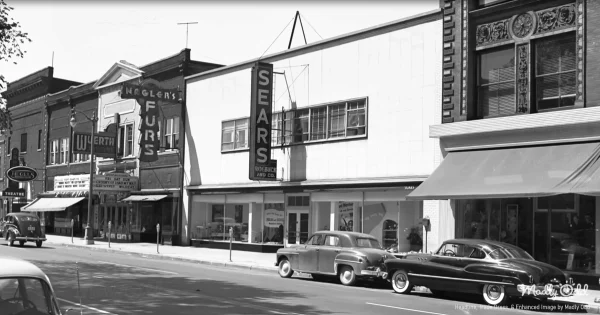 A pristine 1950s Sears department store interior glows under warm fluorescent lights. Smartly dressed shoppers browse endless aisles while the candy counter's glass case sparkles beside stainless steel appliances. Professional salesmen in pressed suits demonstrate the latest Kenmore washer to young couples planning their future.
