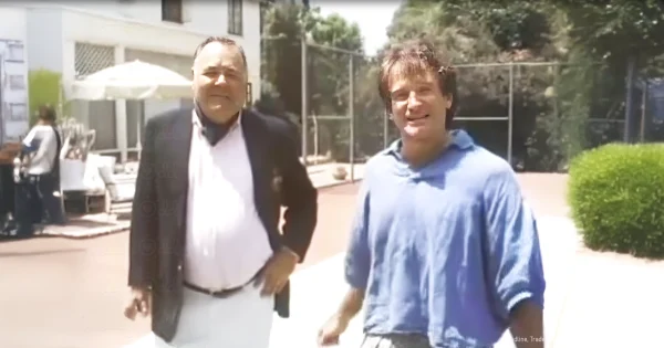 A dimly lit CBS studio, two men in suits facing each other across wooden chairs. The Williams leans forward intently, eyes sparkling with admiration as the WInters gestures wildly mid-character. Ed Bradley watches from the sidelines, fighting to maintain composure.